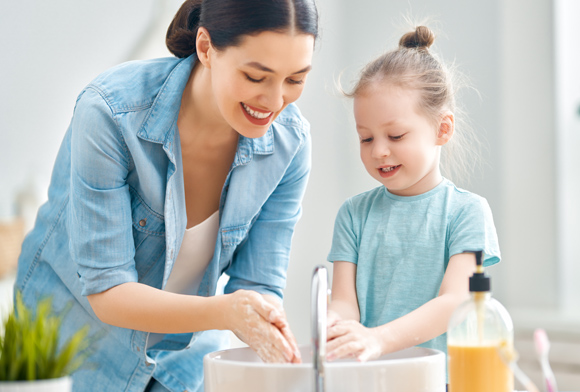 woman and child washing hands