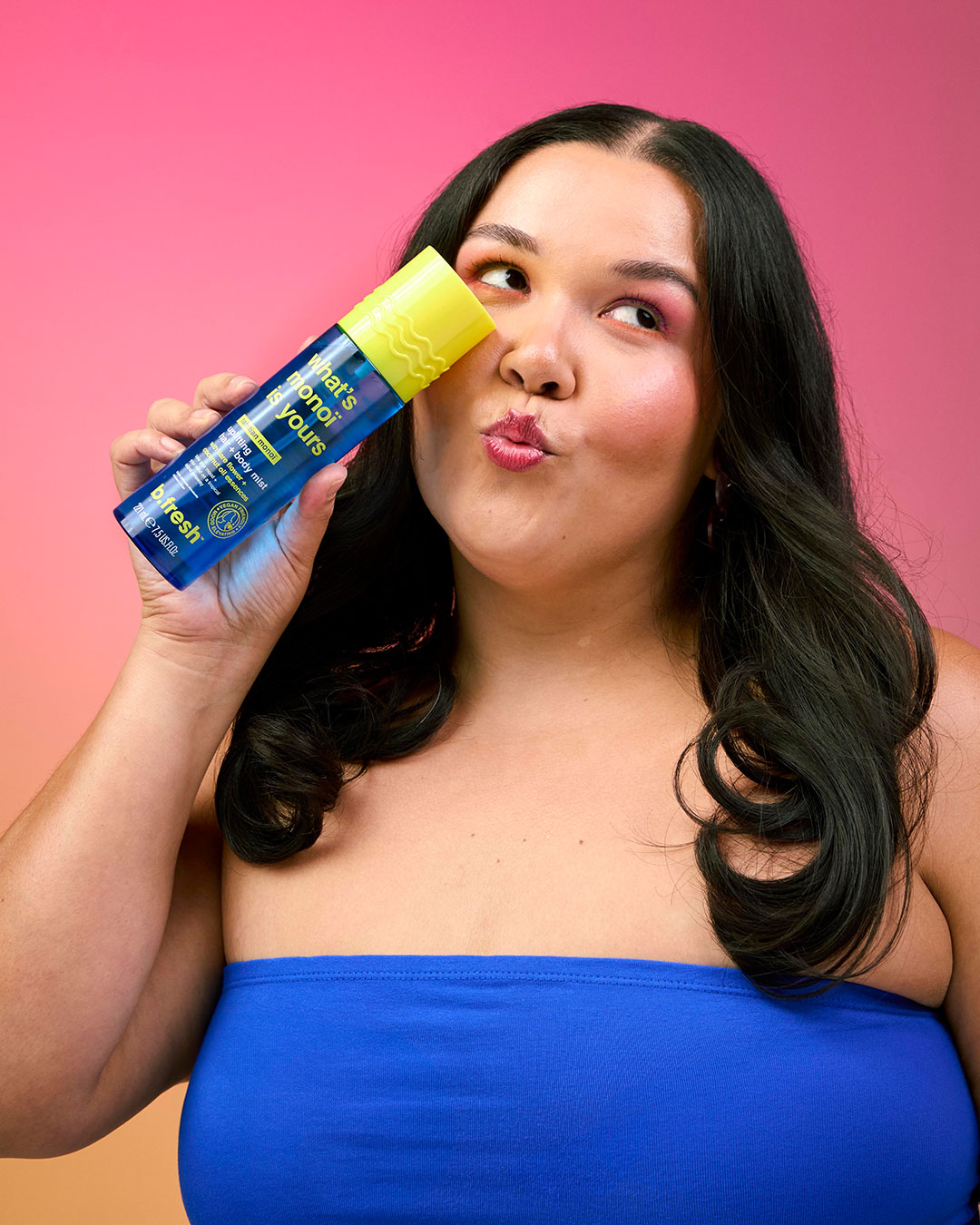 Model holding bottle of b.fresh hair and body mist